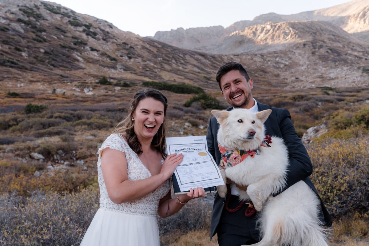 Couple shows off marriage license with their dog as a witness